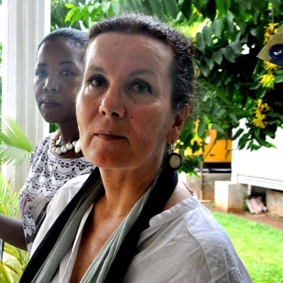 Two women posing for a portrait in a garden.